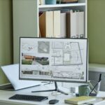 Close up of computer with 3D blueprints